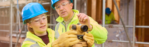 An apprentice learnign to use a Theodolite